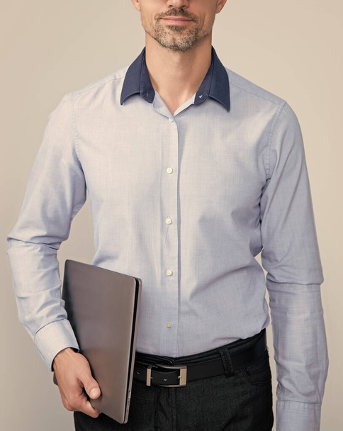 mature man in glasses hold pc on grey background. - Foto, Imagem
