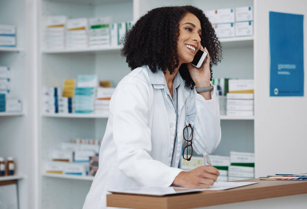 Phone call, counter and pharmacy woman for medicine, customer service or virtual healthcare support. Happy, friendly and expert doctor, medical person or pharmacist talking on cellphone at help desk. - Fotografie, Obrázek