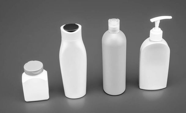 Great for packaging. Bottles for beauty products. Plastic bottles and jar blue background. HDPE. Cosmetic packing. Liquid containers. For toiletry, copy space. - Photo, Image