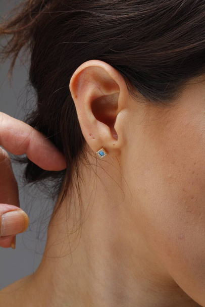 Women earring jewelry model. Cheerful woman with diamond earrings and ring, beautiful face closeup - Zdjęcie, obraz