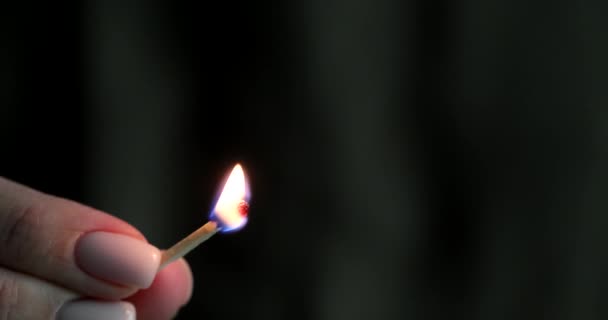 Closeup of match hand lit in dark void. Careless handling of fire - Footage, Video