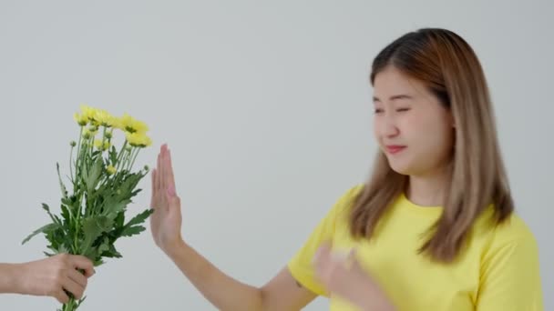 Pollen Allergies, asian young woman sneezing in a handkerchief or blowing in a wipe, allergic to wild spring flowers or blossoms during spring. allergic reaction, respiratory system problems - Footage, Video