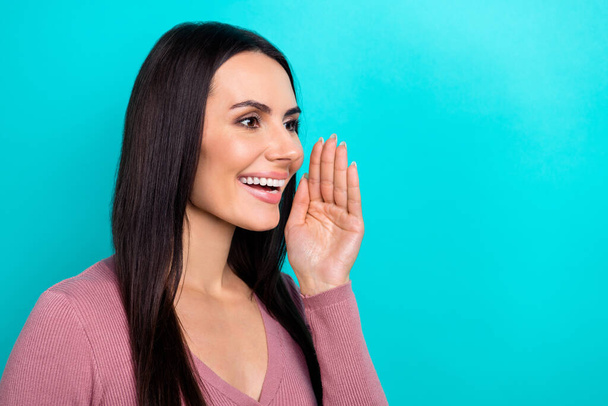 Profile portrait of positive lovely person hand near mouth toothy smile talk communicate empty space isolated on turquoise color background. - Foto, immagini