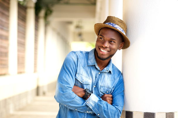 Stylish young man smiling with arms crossed - Photo, Image