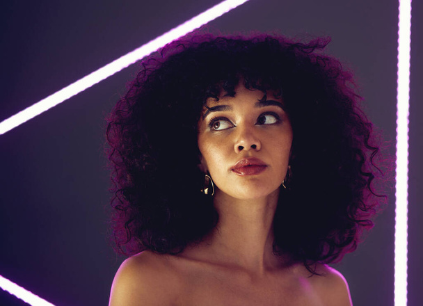 Beauty, purple light and a woman in studio with neon uv for makeup, skin cosmetic and self love. Face of aesthetic gen z black person model on a background for natural afro or art glow and fashion. - Valokuva, kuva