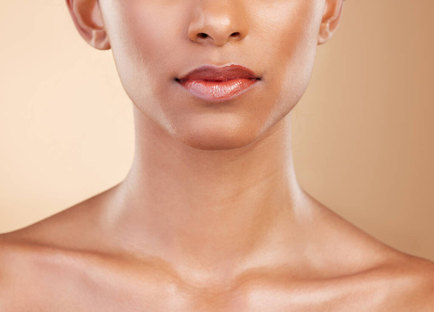 Skincare, face and mouth of a woman with a glow isolated on a studio background. Beauty, makeup and a girl glowing from cosmetics, healthy skin and results from dermatology treatment on a backdrop. - Photo, Image