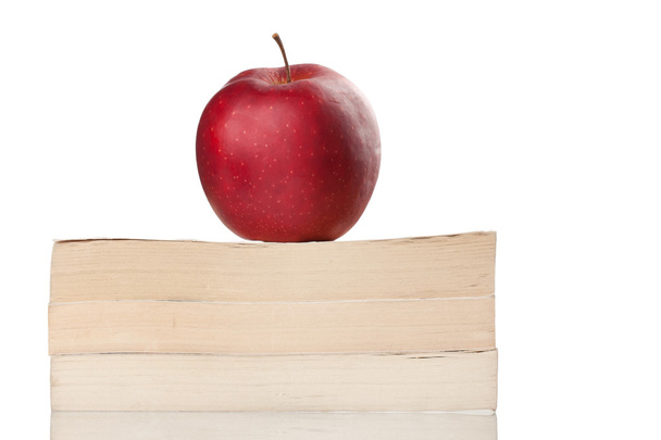 Red apple on a book isolated on white - Fotó, kép
