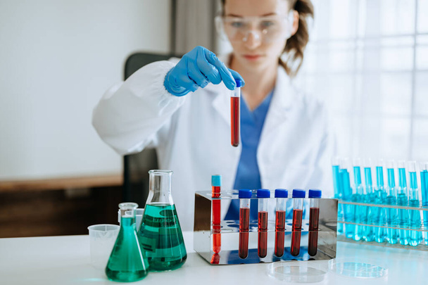 Female biotechnologist testing new chemical substances in a laboratory. - Zdjęcie, obraz