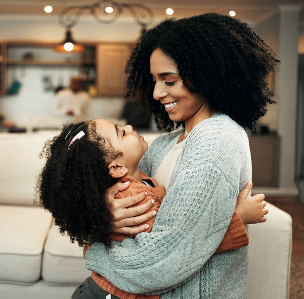 Family, love and child hug mom for Mothers Day, home bonding or embrace in house living room. Care, loving and happy mother or woman smile with female youth kid, girl or daughter in apartment. - Fotoğraf, Görsel