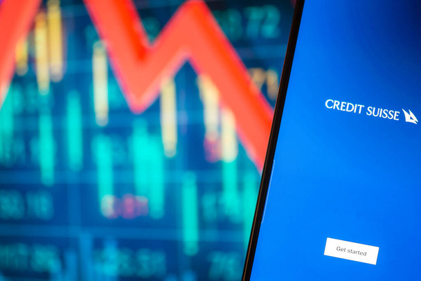 Galati, Romania - March 15, 2023: Smartphone with Credit Suisse bank logo. Credit Suisse stock chart on the background. - Photo, Image