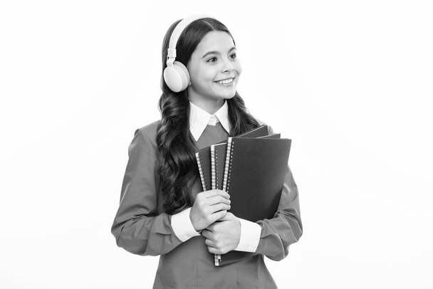 School teen girl in headphones and books, copy space, back to school - Foto, imagen