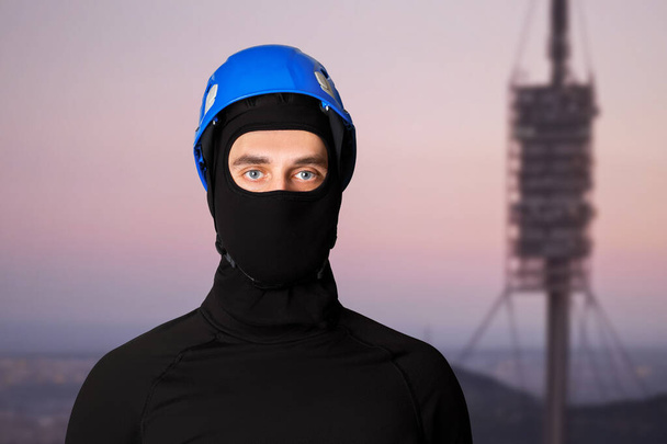 Man, tower worker. Work at height. Radio antenna. In a helmet, protective helmet. - Photo, Image