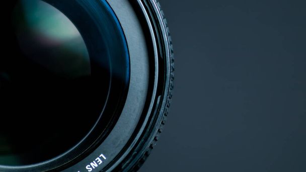 Camera lens on a black background. Close-up of a camera lens. - Photo, Image