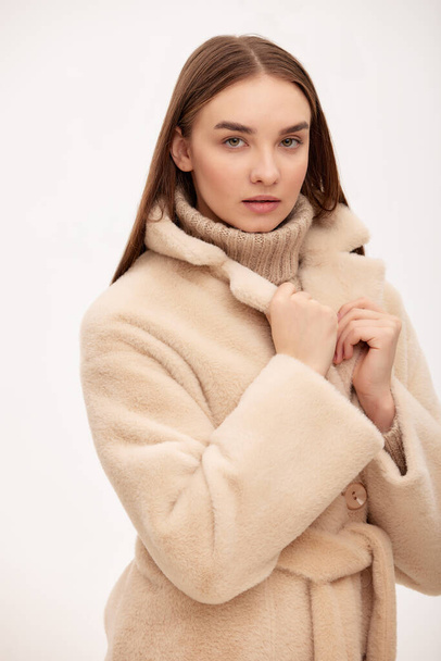 Close-up of a modern business woman on a light background in fashionable faux fur clothes, fashion, modern urban style. - Φωτογραφία, εικόνα
