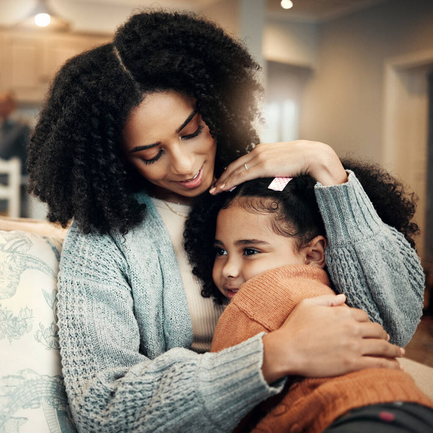 Family, love or kid hug mother for Mothers Day, home bonding or embrace on living room couch. Care, custody and biracial mom, mama or woman with female youth child, girl or daughter on apartment sofa. - Photo, Image