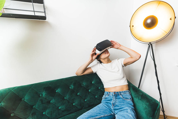 High angle shot. A woman looking up in a VR set on her head. Leisure concept. High quality photo - Photo, image