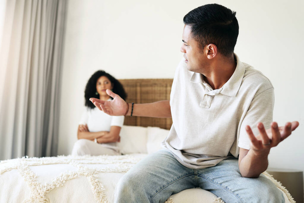 Argument, stress and couple in bedroom for conflict, breakup conversation and communication. Sad, angry and man speaking to a woman about relationship, divorce and frustrated with problem in marriage. - Photo, image