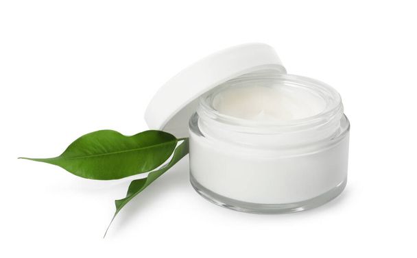 Face cream in glass jar and leaves on white background - Foto, Imagem