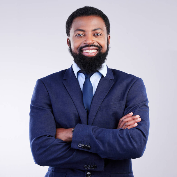 Happy, arms crossed and portrait of black man in studio for professional, corporate and positive. Smile, confident and executive with employee isolated on grey background for pride, happiness and ceo. - Photo, Image