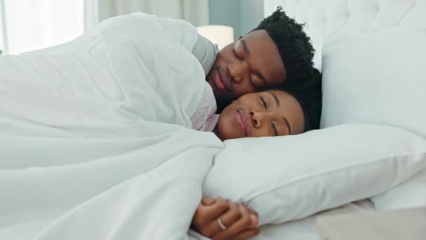 Comfort couple, sleeping in bedroom and morning cuddle for sleep, relax and rest break at home. Happy, love and cozy people in romantic relationship with care, hug and smile together in bedroom. - Footage, Video