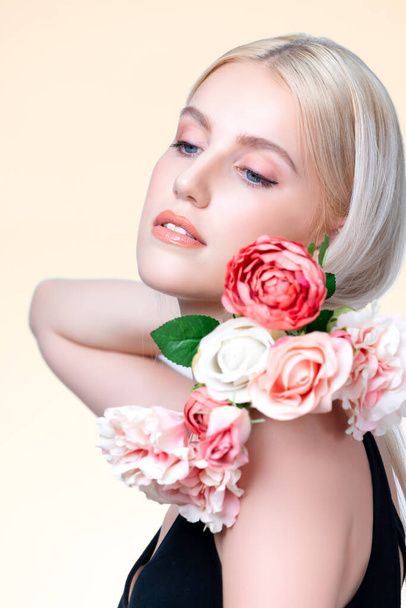 Closeup young personable woman with natural makeup and healthy soft skin holding rose for beauty care advertising in isolated background. Beautiful pretty model girl with flower concept. - Fotó, kép