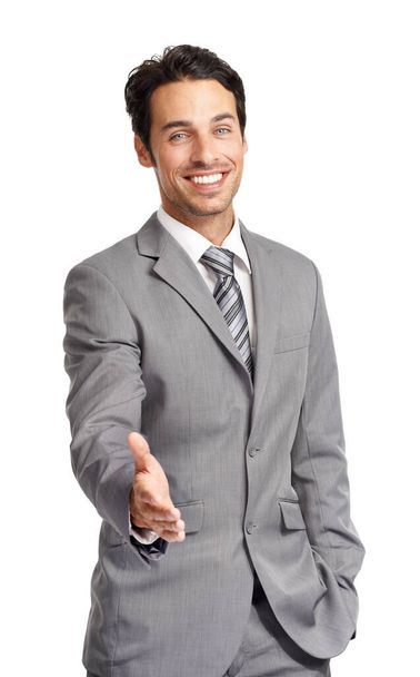 Welcome to the team. A friendly young executive offering you a handshake while isolated on a white background - Foto, imagen