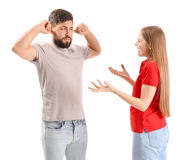Young woman shouting at her husband on white background - Photo, image