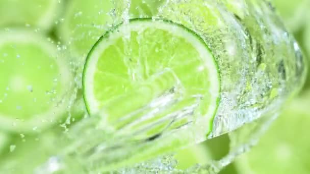 Super Slow Motion Shot of Splashing Water on Rotating Lime Slice at 1000fps. Filmed with High Speed Cinema Camera in 4k. - Footage, Video