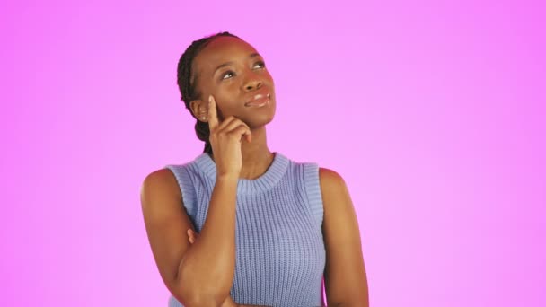 Thinking, thoughtful and black woman in a studio planning a creative idea in her head. Brainstorming, pensive and African female model with a contemplating gesture isolated by a purple background - Footage, Video