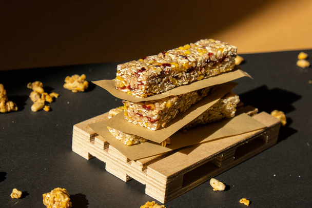 Homemade natural Granola energy bar. Variety of homemade Protein granola breakfast bars with nuts, raisins dried cherries and chocolate. Healthy nutrition eating. Gluten free cereal dieting snack - Photo, Image