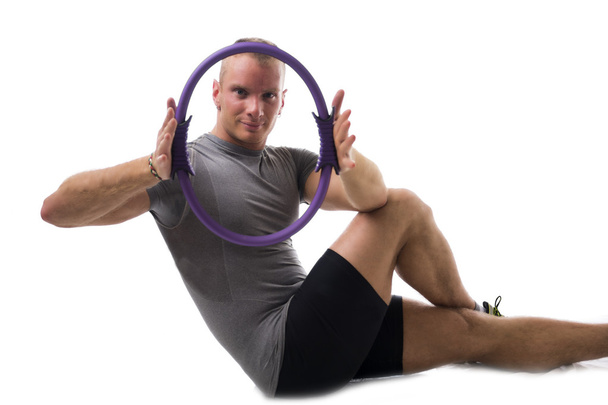 Man working out with pilates ring - Foto, afbeelding