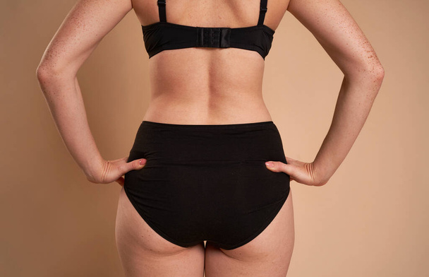 Rear view of buttocks of unrecognizable woman in underwear - Photo, Image