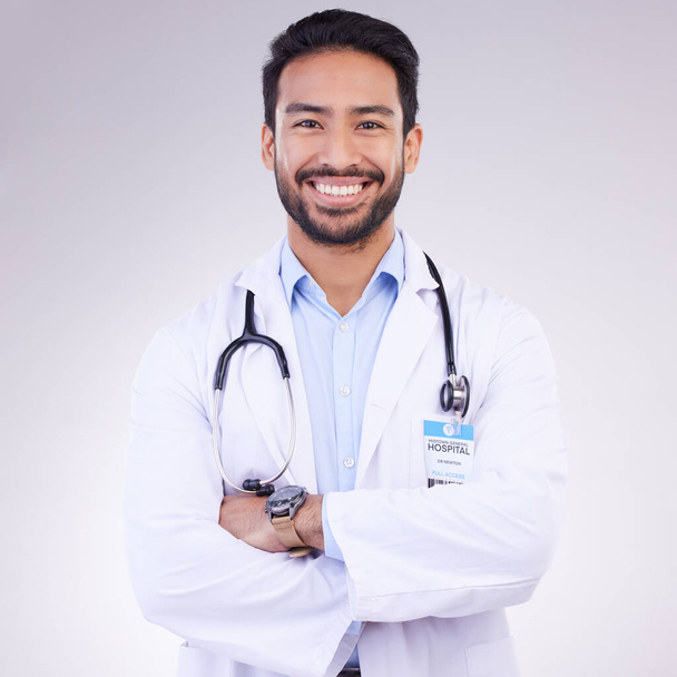 Γιατρός, άνθρωπος με τα χέρια σταυρωμένα και χαρούμενος στο πορτρέτο, την υγεία και την ιατρική επαγγελματική στο φόντο στούντιο. Αρσενικός ιατρός, καρδιοχειρουργός με στηθοσκόπιο, ευτυχία στην ιατρική και mockup. - Φωτογραφία, εικόνα