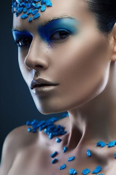 Woman with blue stones on face - Foto, afbeelding