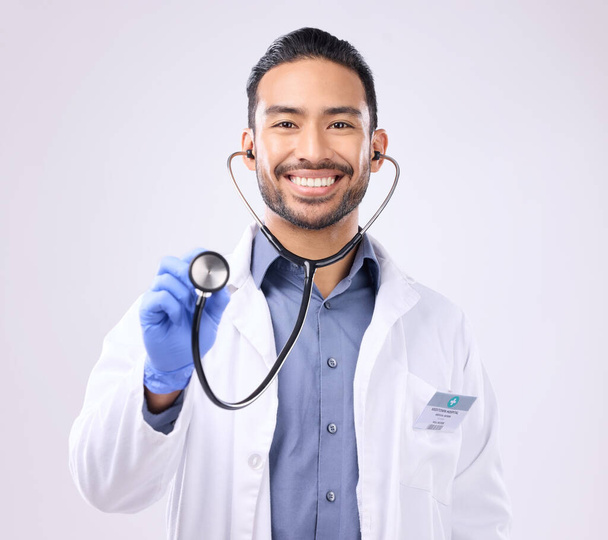 Medical doctor, portrait man or stethoscope for support on healthcare, nurse work or clinic cardiology. Wellness service, studio or happy person with heart beat listening equipment on gray background. - Фото, зображення