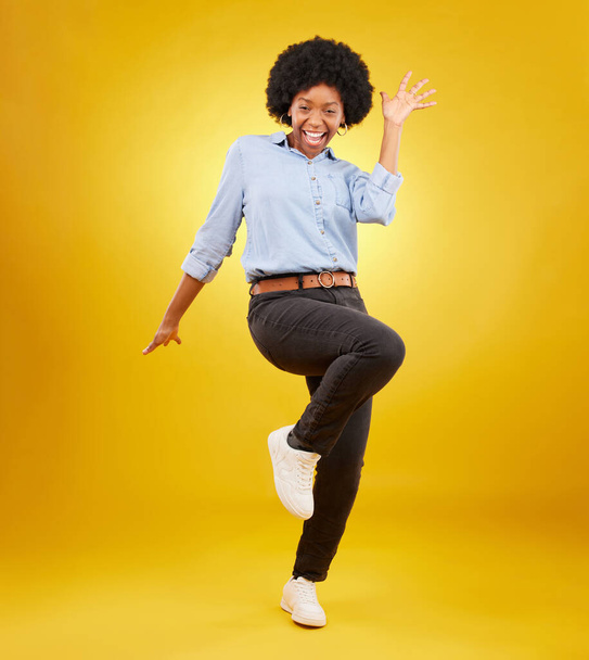 Happy, excited and portrait of black woman on yellow background with energy, happiness and smile in studio. Winner mockup, celebration and isolated girl pose for deal announcement, sale and success. - Photo, image
