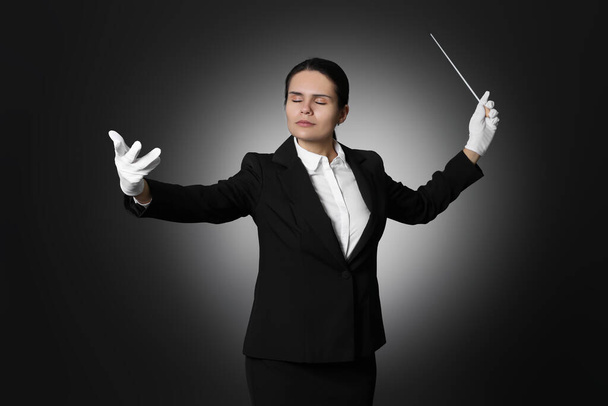Professional conductor with baton on black background - Fotoğraf, Görsel