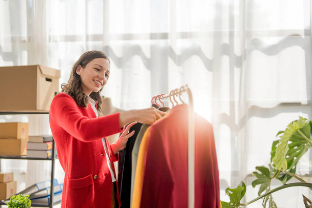 young woman work for checking the clothes in the home, concept e commerce... - Photo, Image