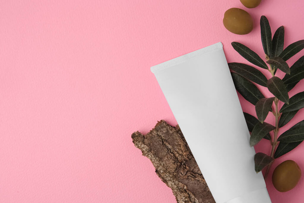 Natural cosmetic. Flat lay composition with olive cream on pink background. Space for text - Fotó, kép