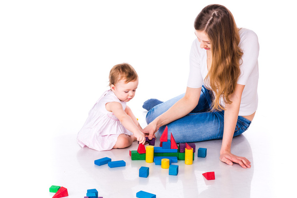 Beautiful baby with mother building with cubes - Foto, immagini