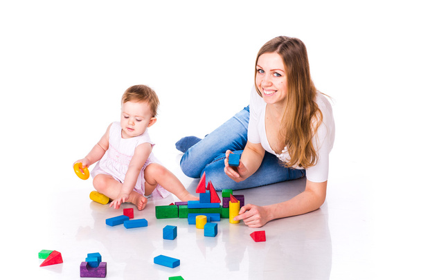 Beautiful baby with mother building with cubes - Photo, image