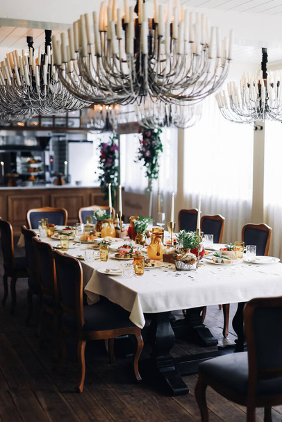 Served table with dishes. On the table are shrimp salad, olivier salad, mashed potatoes with meatballs and an English breakfast. White wine is served for the meal. High quality photo - Photo, image