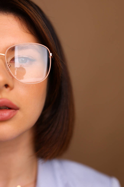 half portrait of a young girl with glasses looking up. High quality photo - Фото, зображення