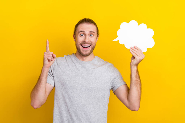 Photo of astonished positive cheerful glad man wear grey trendy clothes rejoice find answer isolated on yellow color background. - Photo, Image