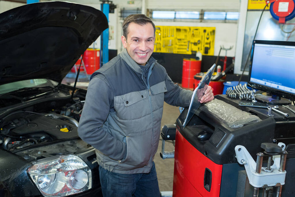handsome auto mechanic at work - Fotó, kép