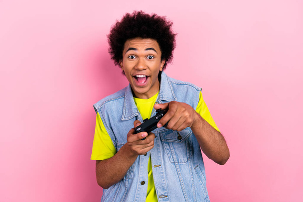 Photo of overjoyed positive person hands hold controller play video games isolated on pink color background. - Photo, Image