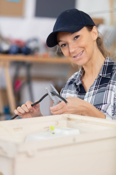 young beautiful repairwoman in her workshop - Photo, Image