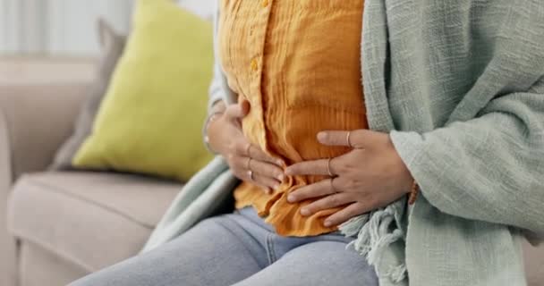 Stomach, cramps and woman with belly ache feeling sick or ill in a home or house with an emergency. Hands, medical and female person abdominal pain, issue or problem with menstrual period. - Footage, Video