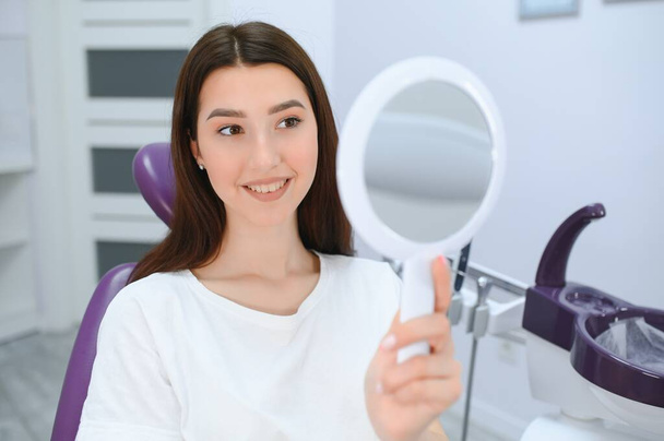 Young smiling woman with beautifiul teeth, having a dental inspection. - Foto, Imagem