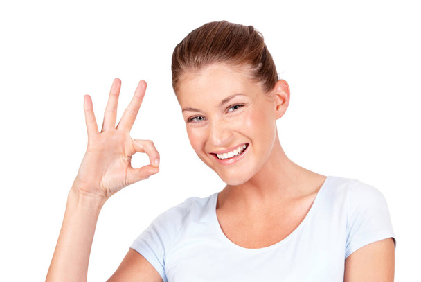 All good. A lovely young woman showing you the a-okay sign while isolated on a white background - Photo, image